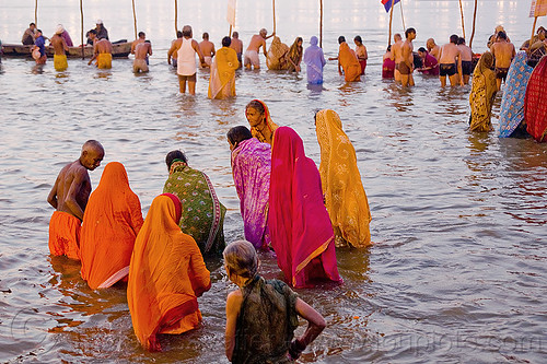 hindu women bathing in the ganges river - kumbh mela 2013 (india), bathing pilgrims, dawn, ganga, ganges river, hindu pilgrimage, hinduism, holy bath, holy dip, indian women, kumbh mela, men, nadi bath, paush purnima, ritual bath, river bathing, saree, triveni sangam