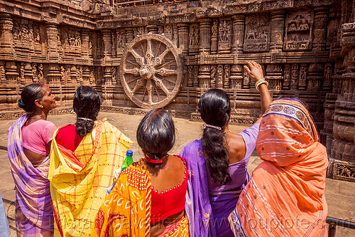 hindu women looking at ancient erotic stone carvings - sculpture - konark sun temple (india), erotic sculptures, erotic stone carving, hindu temple, hinduism, indian women, konark sun temple, maithuna, sarees, saris, stone wheel
