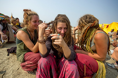 hippie girls making dreadlocks hair, hindu pilgrimage, hinduism, hippie, kumbh mela, rainbow camp, sitting, woman