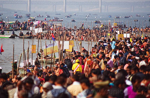 holy bath in ganges river at triveni sangam - kumbh mela 2013 (india), bathing pilgrims, crowd, dawn, fence, ganga, ganges river, hindu pilgrimage, hinduism, holy bath, holy dip, kumbh mela, nadi bath, paush purnima, ritual bath, river bank, river bathing, river boats, triveni sangam