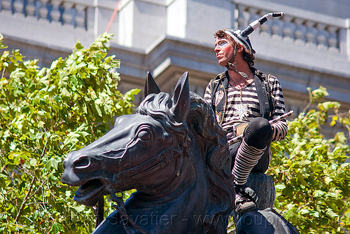 horse head sculpture, costume, faerie freedom village, gay pride festival, horse head, horseback riding, man, monument, sculpture, statue, striped