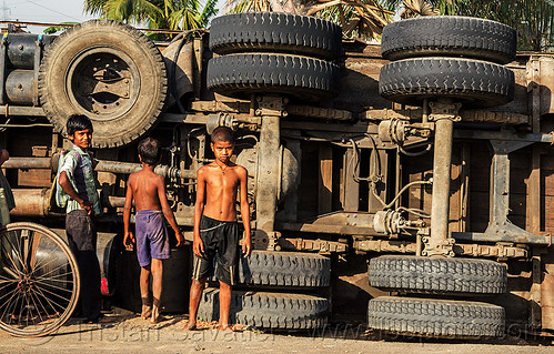 indian boys near underbelly of overturned truck (india), boys, children, crash, lorry accident, overturned truck, road, rollover, tata motors, traffic accident, truck accident, underbelly, wreck