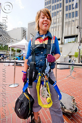 jessika is geared-up with harness and trolley - zip-line over san francisco, adventure, embarcadero, jessika, mountaineering, steel cable, trolley, tyrolienne, urban, woman, zip line, zip wire