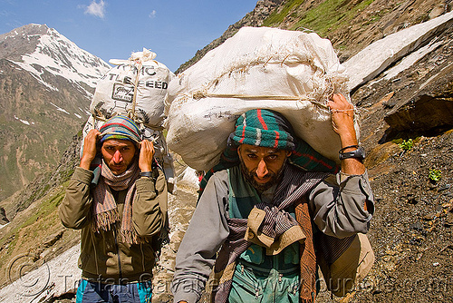 kashmiri load bearers carrying heavy loads on trail - amarnath yatra (pilgrimage) - kashmir, amarnath yatra, bags, hindu pilgrimage, kashmir, load bearers, men, mountain trail, mountains, muslim, pilgrim, snow, wallahs