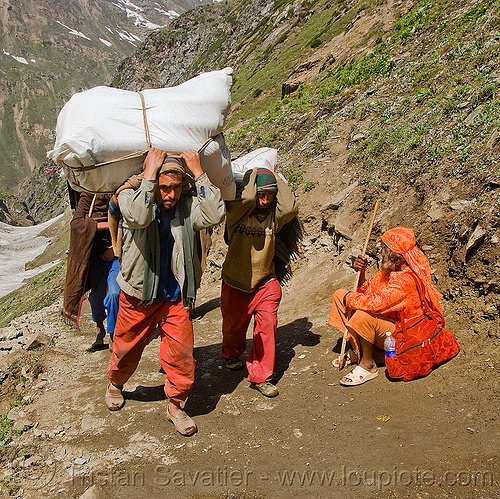 kashmiri load bearers carrying heavy loads on trail - sadhu resting on trail - amarnath yatra (pilgrimage) - kashmir, amarnath yatra, bags, hindu pilgrimage, hinduism, kashmir, load bearers, man, mountain trail, mountains, muslim, pilgrims, resting, sacks, wallahs