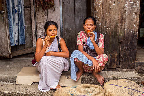 khasi women eating ice pops (india), east khasi hills, ice candy, ice pops, indian woman, indian women, indigenous, italian ice, meghalaya, popsicles, pynursla, sitting, water ice