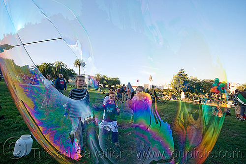 kids behind giant soap bubble, big bubble, children, giant bubble, iridescent, kids, lawn, park, playing, soap bubbles