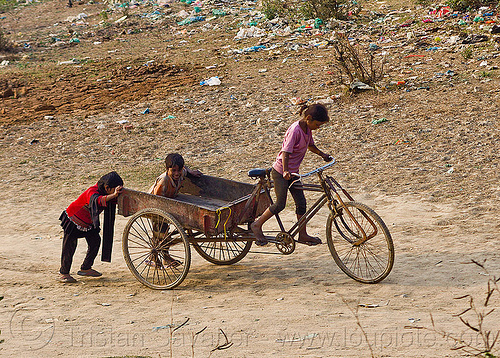 kids playing with freight tricycle (india), boy, cargo tricycle, cargo trike, children, environment, freight tricycle, freight trike, garbage, girl, kids, plastic trash, playing, pollution, riding
