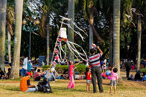 kite merchant in park (jakarta), children, eid ul-fitr, flying, jakarta, kids, kites, lawn, medan merdeka, men, merchant, merdeka square, park, pole, rubans, streamers, street seller, street vendor, trees