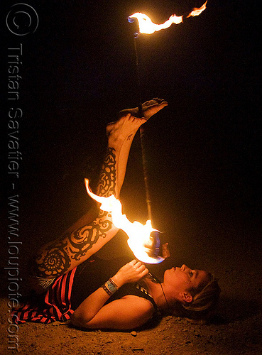 leg tattoo - lily spinning fire staff with feet (san francisco), fire dancer, fire dancing, fire performer, fire spinning, fire staff, leg tattoo, night, spinning fire, tattooed, tattoos, woman