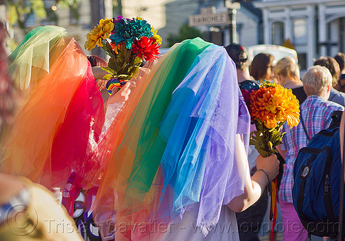 lesbian couple in rainbow color wedding dresses, bridal bouquets, brides, gay couple, gay marriage, gay pride festival, gay wedding, lesbian couple, rainbow colors, same-sex marriage, same-sex wedding, veils, wedding bouquet, wedding dresses, women