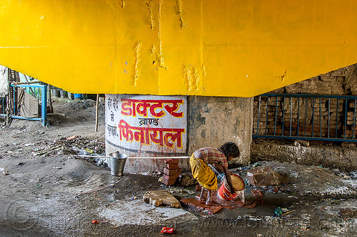 little girl rinsing bucket at water hose, bridge pillar, child, daraganj, hindu pilgrimage, hinduism, kid, kumbh mela, little girl, metal bucket, plastic pipe, plastic piping, steel bucket, water hose, water pipe