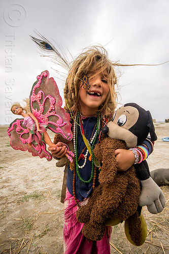 little hippie girl with pink butterfly barbie doll - ilita, baby teeth, barbie butterfly, barbie doll, blonde, child, hindu pilgrimage, hinduism, hippie, ilita, kid, kumbh mela, little girl, mickey mouse doll, missing teeth, necklaces, peacock feather, pink butterfly wings, teddybear, toys