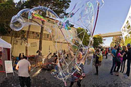 making giant soap bubbles with mesh of rope, giant soap bubble