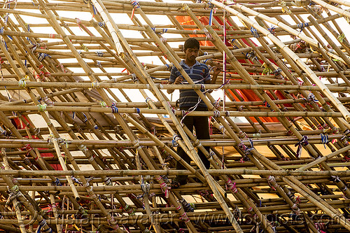 man in bamboo mesh structure (india), ashram, bamboo mesh, bamboo structure, broken, collapsed, destruction, gate, hindu pilgrimage, hinduism, kumbh mela