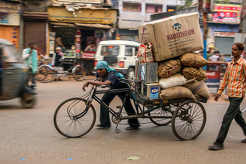man pushing cargo tricycle with heavy load (india), bags, boxes, cargo tricycle, cargo trike, freight tricycle, freight trike, heavy, load bearer, men, moving, sacks, transport, transportation, transporting, varanasi, walking, wallah