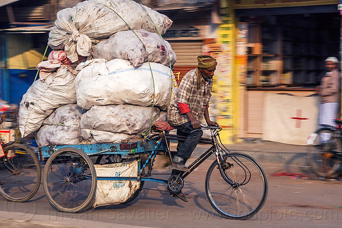 man transporting large load of freight on tricycle (india), bags, cargo tricycle, cargo trike, freight tricycle, freight trike, heavy, load bearer, man, moving, riding, sacks, transport, transportation, transporting, varanasi, wallah