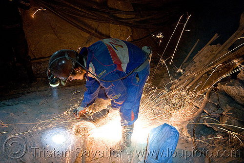 miner grinding metal, bolivia, cerro rico, cutting, grinder, grinding, man, mina candelaria, mine tunnel, mine worker, miner, mining, potosí, safety helmet, sparks, underground mine