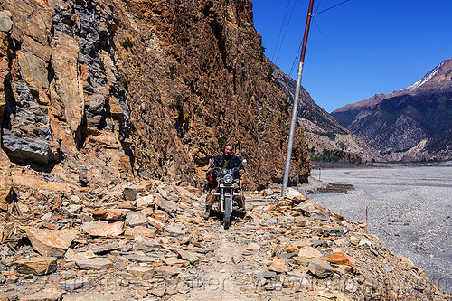motorbike on rocky road - annapurnas (nepal), 350cc, annapurnas, cliff, dirt road, kali gandaki valley, motorcycle touring, mountain road, rider, riding, rocks, royal enfield bullet, thunderbird, unpaved