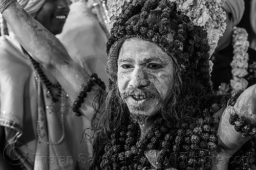 naga baba with ritual rudraksha beads - kumbh mela (india), beard, hat, headwear, hindu pilgrimage, hinduism, holy ash, kumbh mela, men, naga babas, naga sadhus, necklaces, night, rudraksha beads, sacred ash, sadhu, vasant panchami snan, vibhuti, walking