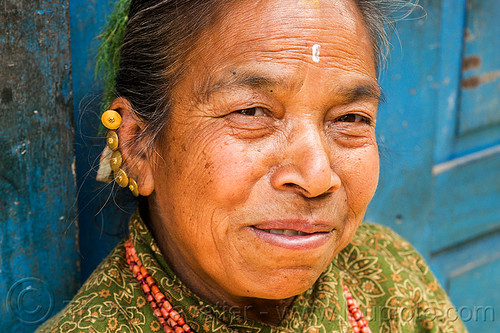 nepali hindu woman with multiple helix ear piercings and gold earrings (nepal), bhaktapur, ear piercing, earrings, helix piercing, jewelry, tilak, tilaka, woman