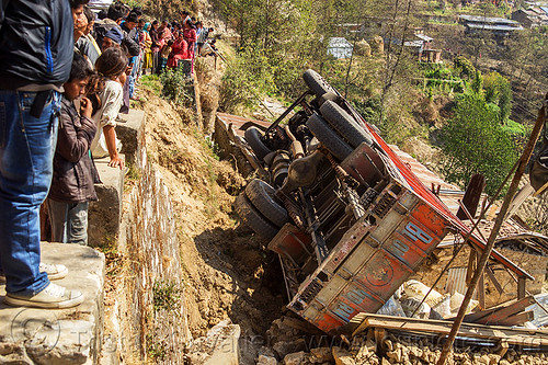 nepali villagers looking at overturned truck off mountain road (nepal), crash, ditch, lorry accident, mountain road, overturned, rollover, tata motors, traffic accident, truck accident, underbelly, up-side-down, wreck