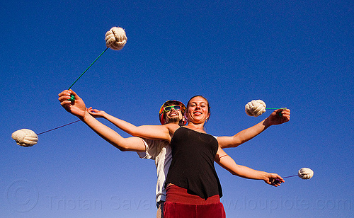 partner poi - two people spinning poi together, ball, blue sky, cary, man, partner poi, rope, savanna, training poi, woman