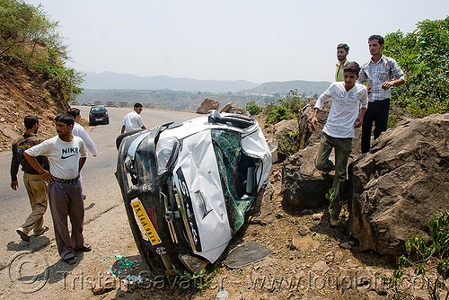 people around overturned car, car accident, car crash, kashmir, overturned car, road, rollover, tata indica, tata motors, traffic accident, white, wreck