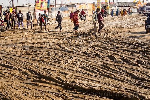people walking on muddy road (india), hindu pilgrimage, hinduism, intersection, kumbh mela, mud ruts, muddy road, muddy street, walking
