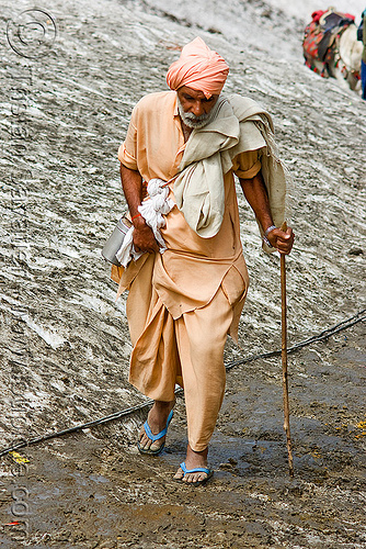 pilgrim in flip-flop shoes on glacier trail - amarnath yatra (pilgrimage) - kashmir, amarnath yatra, flip-flops, glacier, hiking cane, hindu pilgrimage, kashmir, mountain trail, mountains, pilgrim, sandals, walking stick
