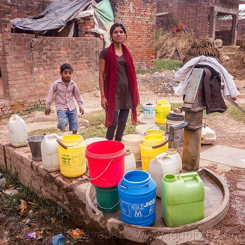 plastic water containers near hand pump (india), boy, child, hand pump, khoaja phool, kid, plastic jugs, village, water jugs, water pump, woman, खोअजा फूल