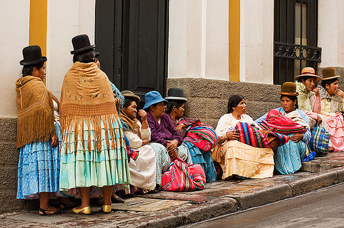 quechua women - street - la paz (bolivia), bolivia, bowler hats, curb, indigenous, la paz, quechua, sidewalk, sitting, squat, squatting, women