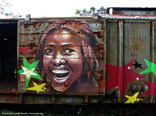 rasta-girl painting on train car - puerto limon (costa rica), atlantic railway, costa rica, freight train car, graffiti, mural, paint, painted, painting, puerto limon, rusty, stars, train depot, train yard, trespassing