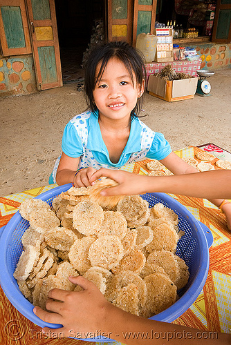 rice cookies - home made - girl - laos, little girl, rice cakes, rice cookies, street market, street seller, street vendor