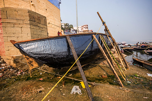 river boat with new tar coating - ghats of varanasi (india), drying, ganga, ganges river, ghats, hull, river boat, tar, varanasi