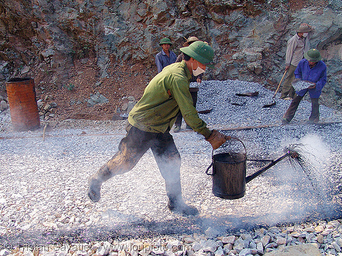 road paving - spraying hot asphalt over gravel with watering can - vietnam, face mask, gravel, groundwork, hot asphalt, hot bitumen, men, pavement, paving, road construction, roadworks, smoke, smoking, spraying, watering can, workers, working