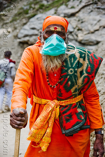 sadhu (hindu holy man) with dust mask on trail - amarnath yatra (pilgrimage) - kashmir, amarnath yatra, beard, bhagwa, dust mask, hindu pilgrimage, hinduism, holy man, kashmir, mountain trail, mountains, old man, pilgrim, saffron color, tilak, tilaka
