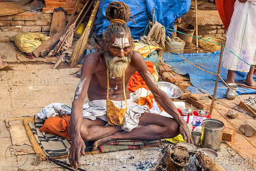 sadhu sitting cross-legged with threatening eyes (nepal), baba, beard, bonfire, cross-legged, dreadlocks, hindu, hinduism, kathmandu, knotted hair, maha shivaratri, man, pashupatinath, sadhu, sitting, tilak, tilaka
