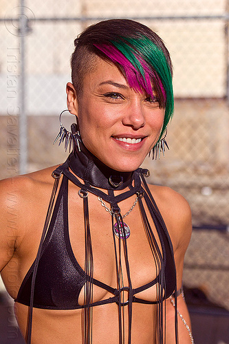 scanty black top with hanging strings, black outfit, fashion, green and pink hair, identical twin, monique, pink and green hair, scanty top, spiky earrings, woman
