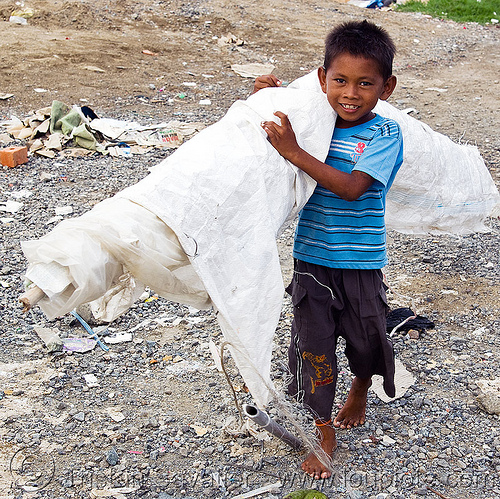 scavenger kid carrying white tarp, borneo, boy, child, garbage, homeless camp, kid, lahad datu, malaysia, poor, roll, scavenger, tarp, trash