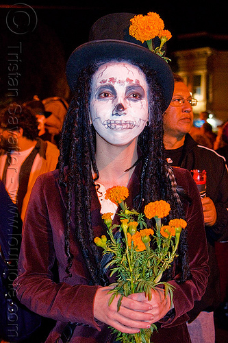 skull makeup and orange marigold flowers - tagetes, day of the dead, dia de los muertos, dreadlocks, face painting, facepaint, halloween, hat, holding flowers, night, orange flowers, orange marigold, skull makeup, tagetes, woman