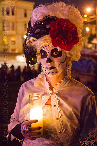 skull makeup and victorian attire - white wig - red flower headdress, candle light, class candle, day of the dead, dia de los muertos, face painting, facepaint, halloween, lace, mexican candle, night, red flower headdress, sugar skull makeup, white wig, woman