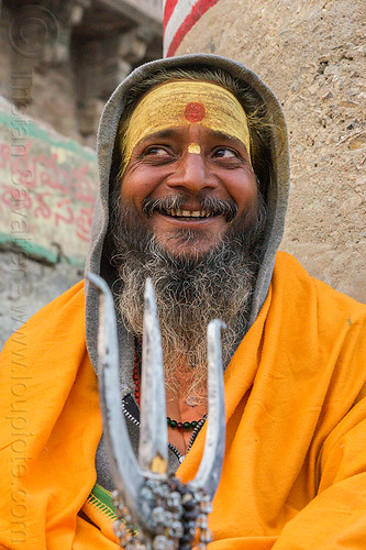 smiling sadhu with trident - hindu holy man (india), baba, beard, bhagwa, hindu man, hinduism, sadhu, saffron color, tilak, tilaka, trident, varanasi