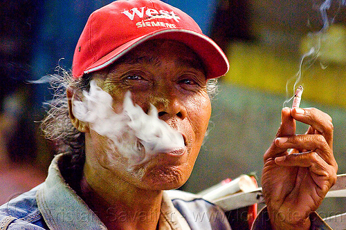 smoking man exhaling smoke (indonesia), cap, cigarette, exhaling, hand, malioboro, man, night, rickshaw driver, smoke, smoker, smoking