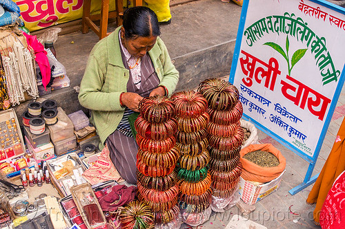 stacks of bracelets in almora street market (india), almora, bracelets, bundles, indian woman, loose tea, selling, sign, sitting, stacks, stall, street market, street seller, street vendor, tea leaves