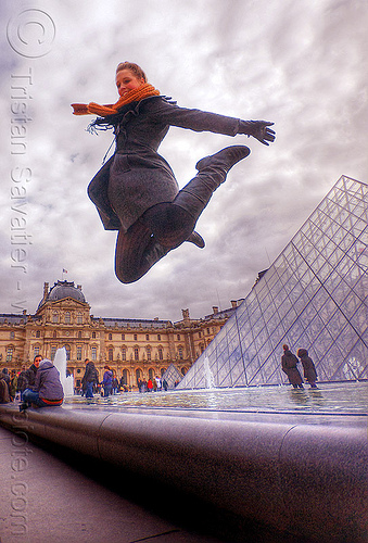 tourist near the glass pyramid at le louvre museum (paris), clouds, crowd, fountain, jump shot, le louvre, pyramid, scarf, sophie, tourists, woman