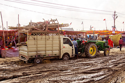 tractor pulling small truck stuck in mud (india), car, farm tractor, hindu pilgrimage, hinduism, kumbh mela, lorry, mud ruts, muddy road, muddy street, towed, towing, truck