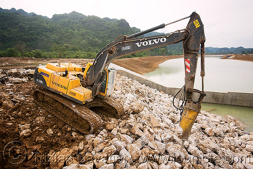 volvo ec210 excavator - downstream canal - nam theun 2 hydroelectric project (laos), at work, attachment, construction, hydraulic breaker, hydraulic hammer, hydro-electric, nam theun 2 hydroelectric project, nam theun power company, ntpc, rocks, rubble, volvo ec210, volvo ec210b excavator, volvo ec210blc excavator, volvo excavator, working