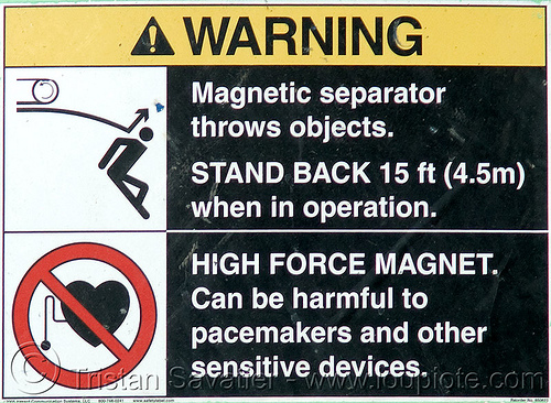warning sign on concrete shredder - strong magnetic field - danger - building demolition, building demolition, concrete shredder, danger, dangerous, hazard, magnet, magnetic field, magnetic separator, sign, stick figure, warning