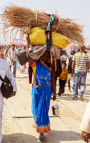 woman carrying bags and hay over head (india), bag, bundle, carrying on the head, crowd, hay, hindu pilgrimage, hinduism, kumbh mela, load bearer, luggage, sack, walking, wallah